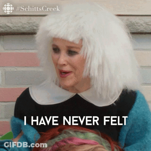 A Woman Wearing A White Wig And A Blue Sweater Says I Have Never Felt GIF