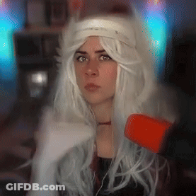 A Woman Wearing A White Wig And A Headband Is Looking At The Camera GIF