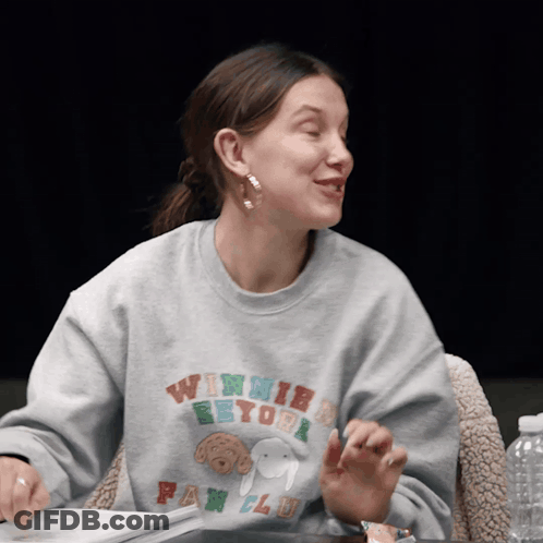 A Woman Wearing A Winnie The Pooh Fan Club Shirt GIF