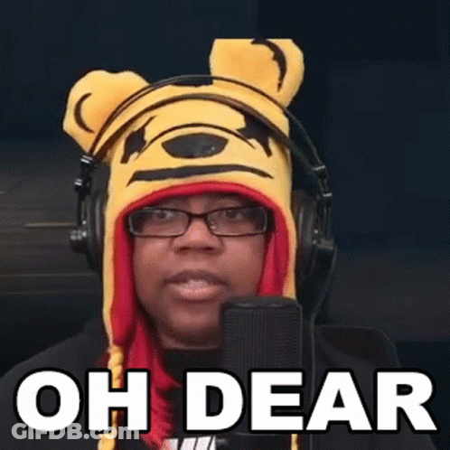 A Woman Wearing A Winnie The Pooh Hat And Headphones Is Speaking Into A Microphone . GIF