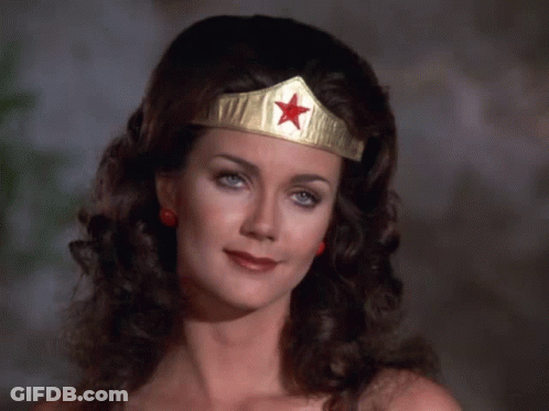 A Woman Wearing A Wonder Woman Headband With A Red Star GIF