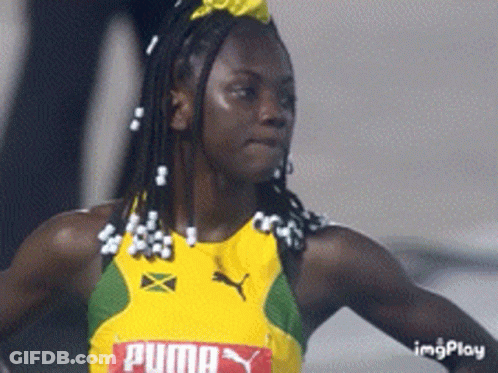 A Woman Wearing A Yellow And Green Puma Jersey GIF