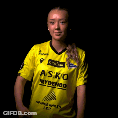A Woman Wearing A Yellow Asko Rydenbo Shirt GIF