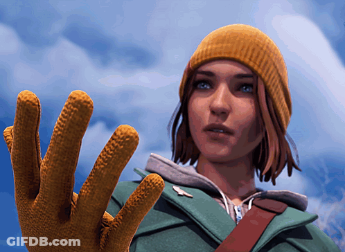 A Woman Wearing A Yellow Hat And A Green Jacket Holds Up Her Glove GIF