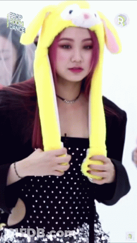 A Woman Wearing A Yellow Hat With Bunny Ears And The Words Prop Room Dance On The Bottom GIF