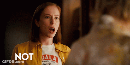 A Woman Wearing A Yellow Jacket And A Dala Shirt GIF