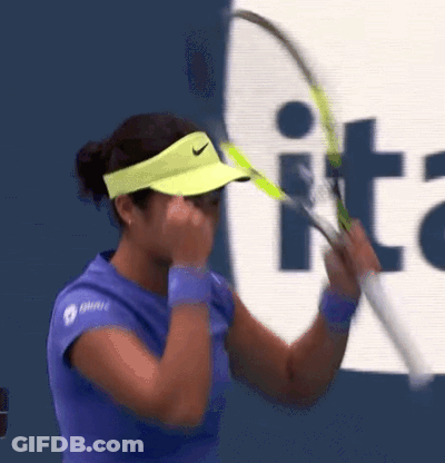 A Woman Wearing A Yellow Nike Visor Is Holding A Tennis Racket GIF