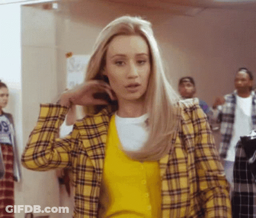 A Woman Wearing A Yellow Plaid Jacket And A Yellow Sweater With The Number 99 On It GIF