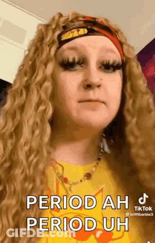 A Woman Wearing A Yellow Shirt And A Red Headband Says " Period Ah Period Uh " GIF