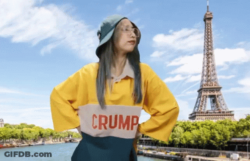 A Woman Wearing A Yellow Shirt That Says Crump GIF