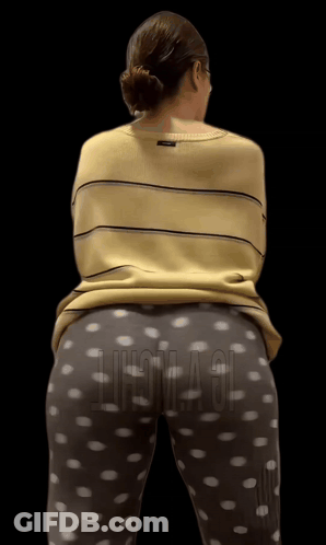A Woman Wearing A Yellow Striped Shirt And Polka Dot Pants Stands In Front Of A Black Background That Says Chicago GIF