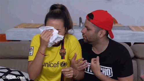 A Woman Wearing A Yellow Unicef Shirt Is Crying GIF