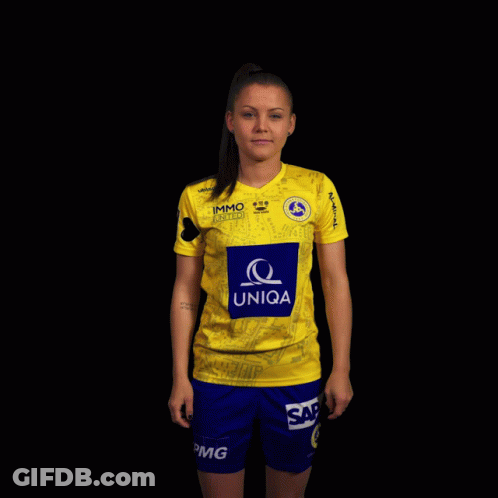 A Woman Wearing A Yellow Uniqa Shirt And Blue Shorts GIF