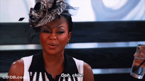 A Woman Wearing A Zebra Print Hat Says Ooh Child While Holding A Glass Of Water GIF