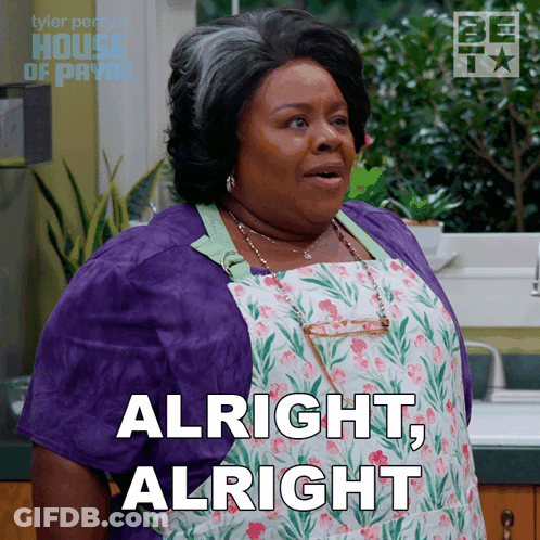 A Woman Wearing An Apron And A Purple Jacket Says " Alright Alright " GIF