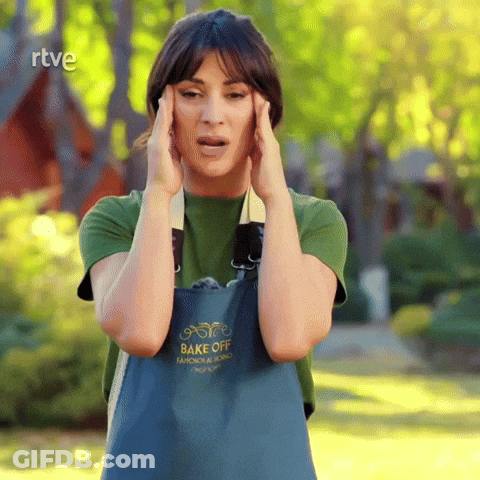 A Woman Wearing An Apron That Says Bake Off Holds Her Head GIF
