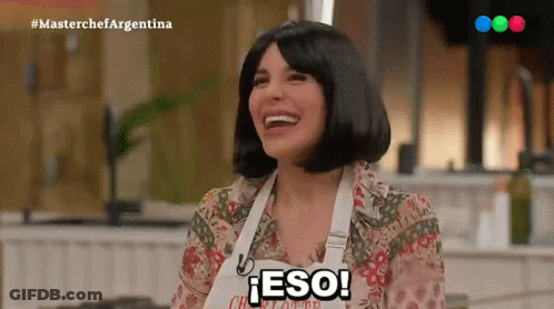 A Woman Wearing An Apron That Says Eso Is Laughing GIF