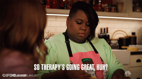 A Woman Wearing An Apron That Says " So Therapy 'S Going Great Huh " Talks To Another Woman GIF