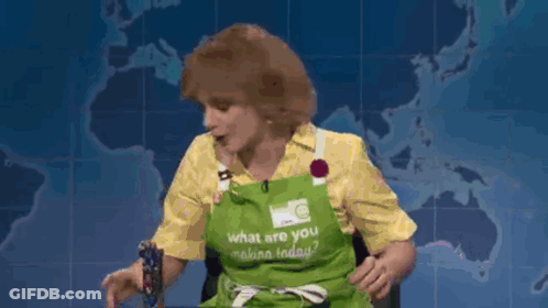 A Woman Wearing An Apron That Says What Are You Making Today GIF