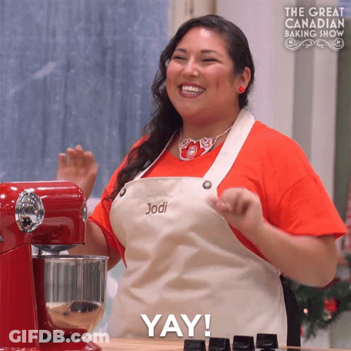 Woman In Apron Named Jodi In Front Of Red Mixer GIF