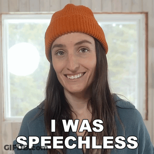 A Woman Wearing An Orange Hat Is Smiling And Says I Was Speechless GIF