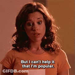 A Woman Wearing An Orange T-Shirt Says But I Can 'T Help It That I 'M Popular GIF