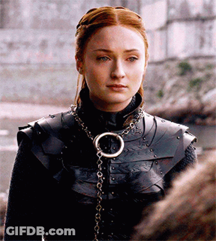 A Woman Wearing Armor And A Necklace With A Ring On It GIF