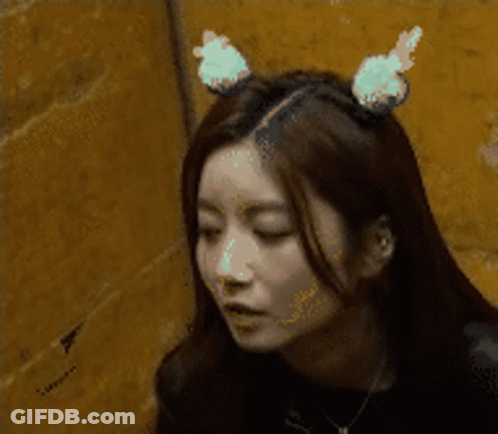 A Woman Wearing Bunny Ears On Her Head GIF
