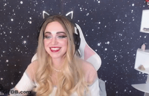 A Woman Wearing Cat Ears And Headphones Is Smiling In Front Of A Starry Background . GIF