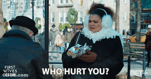 A Woman Wearing Ear Muffs Is Talking To An Older Man And Asking Who Hurt You GIF