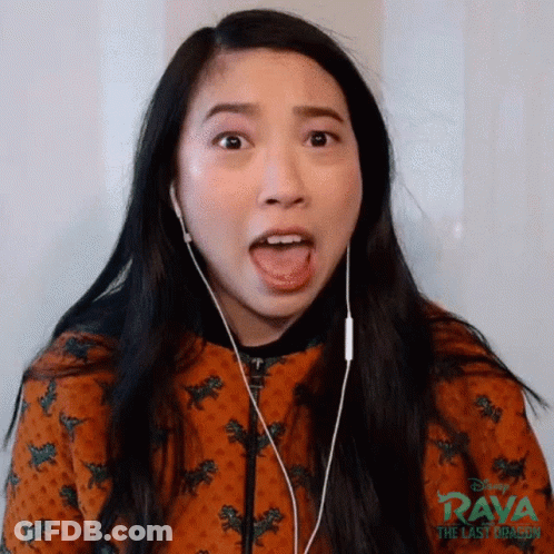 A Woman Wearing Earphones Is Making A Funny Face . GIF