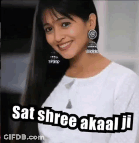 A Woman Wearing Earrings And A White Shirt Is Smiling And Says Sat Shree Akaal Ji GIF