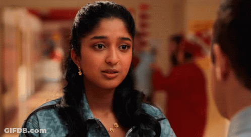 A Woman Wearing Earrings Looks At A Man GIF