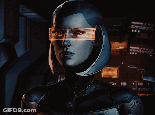 A Woman Wearing Futuristic Glasses Looks At The Camera With A Dark Background GIF