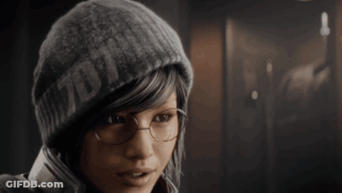 A Woman Wearing Glasses And A Beanie That Says ' 7D11 ' On It GIF