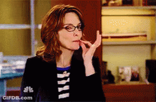 A Woman Wearing Glasses And A Black Jacket With The Letters Nbc On It GIF