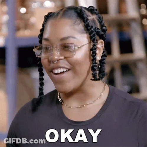 A Woman Wearing Glasses And A Black Shirt Is Smiling And Says Okay GIF