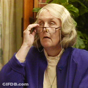 A Woman Wearing Glasses And A Blue Jacket GIF