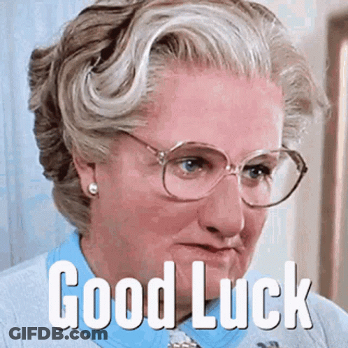 A Woman Wearing Glasses And A Blue Shirt Has The Words Good Luck On Her Face GIF