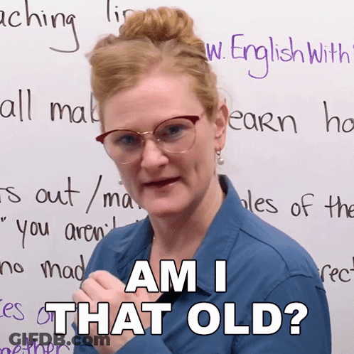A Woman Wearing Glasses And A Blue Shirt Says " Am I That Old " GIF