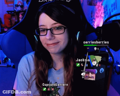 A Woman Wearing Glasses And A Blue Shirt That Says Cups And Lantern Is Smiling GIF