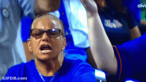 A Woman Wearing Glasses And A Blue Shirt With The Word Miami On It Looks Angry GIF