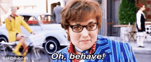 A Woman Wearing Glasses And A Blue Suit Is Saying `` Oh , Behave '' . GIF
