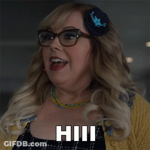 A Woman Wearing Glasses And A Flower In Her Hair Says Hill GIF