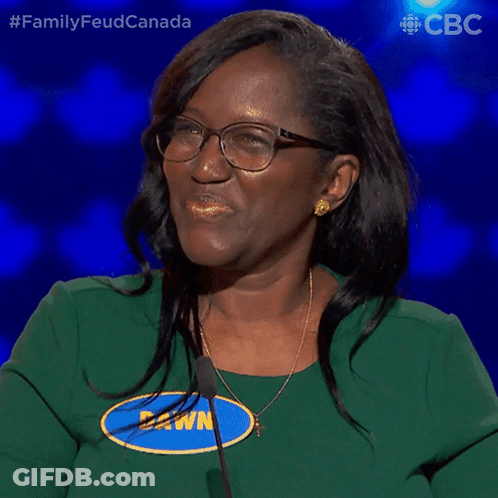 A Woman Wearing Glasses And A Green Shirt Says " Yes " GIF