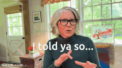 A Woman Wearing Glasses And A Green Sweater Says I Told Ya So GIF