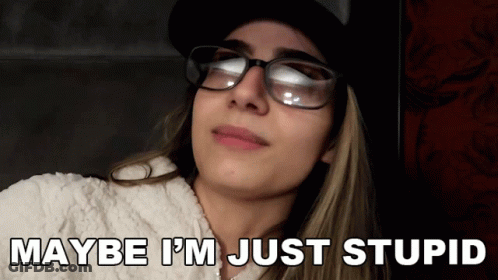 A Woman Wearing Glasses And A Hat With The Words Maybe I 'M Just Stupid Below Her GIF