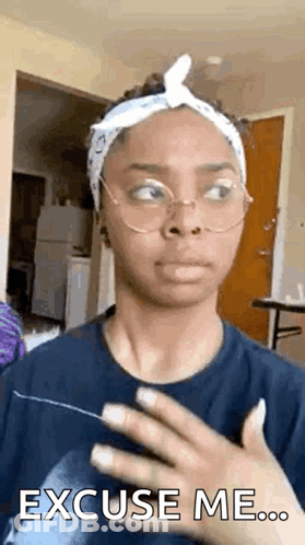 A Woman Wearing Glasses And A Headband Is Making A Funny Face And Saying `` Excuse Me '' . GIF