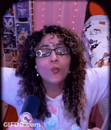 A Woman Wearing Glasses And A Hello Kitty Shirt GIF