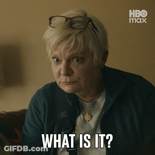 A Woman Wearing Glasses And A Necklace Says What Is It GIF